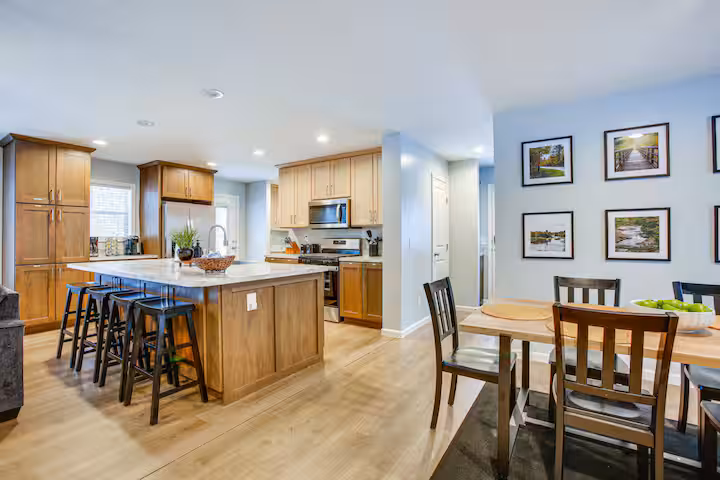 Kitchen island with bar seating opening to the dining room
