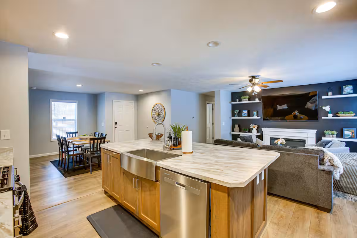 Modern kitchen with large island and stainless appliances at Pine River Ranch
